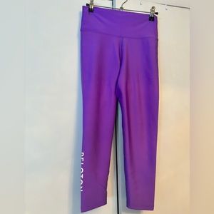 Size XL purple Peloton high-waist ankle leggings.